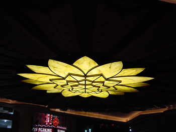 A flower shaped stained glass dome shines with yellow light