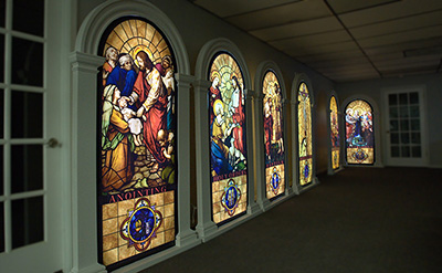 A wall is filled with LED lit stained glass panels