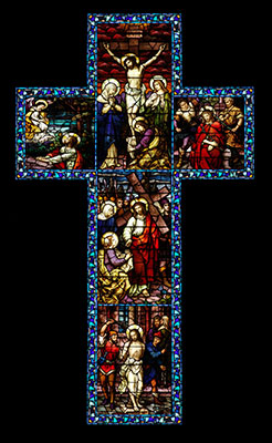 A stained glass cross representing the passion and death of Jesus.