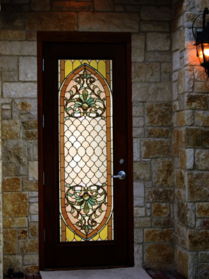 A simple door is decorated with a stained glass window insert that truly makes it shine. Greet visitors with colorful stained glass inserts in your doors.