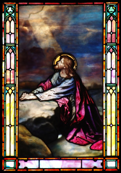 Stained glass image of Christ praying in Gethsemane