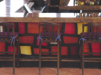 The front side of a seaside bar s covered in colorful stained glass